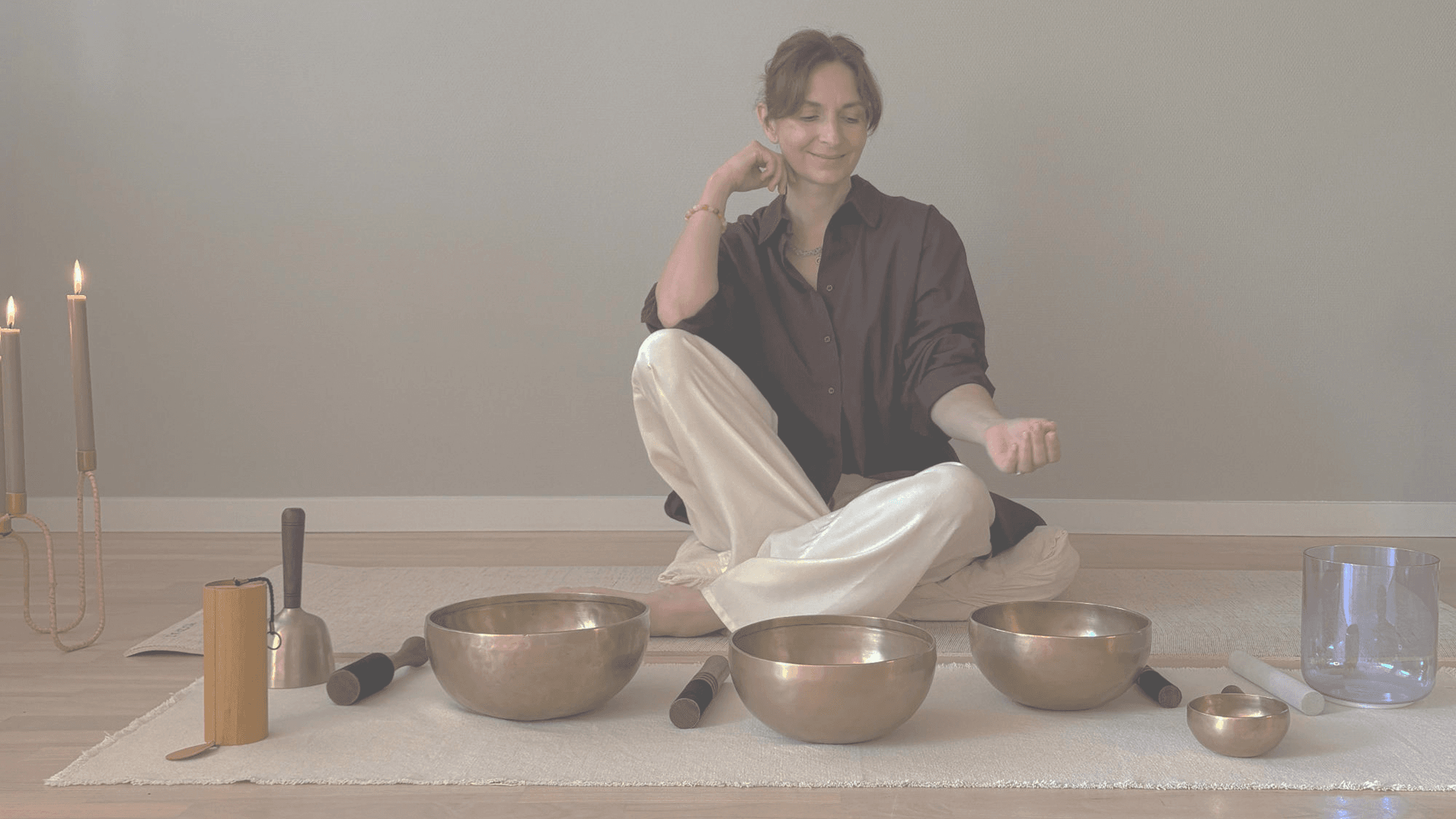 Michèle Gabrielle seated with singing bowls and candles