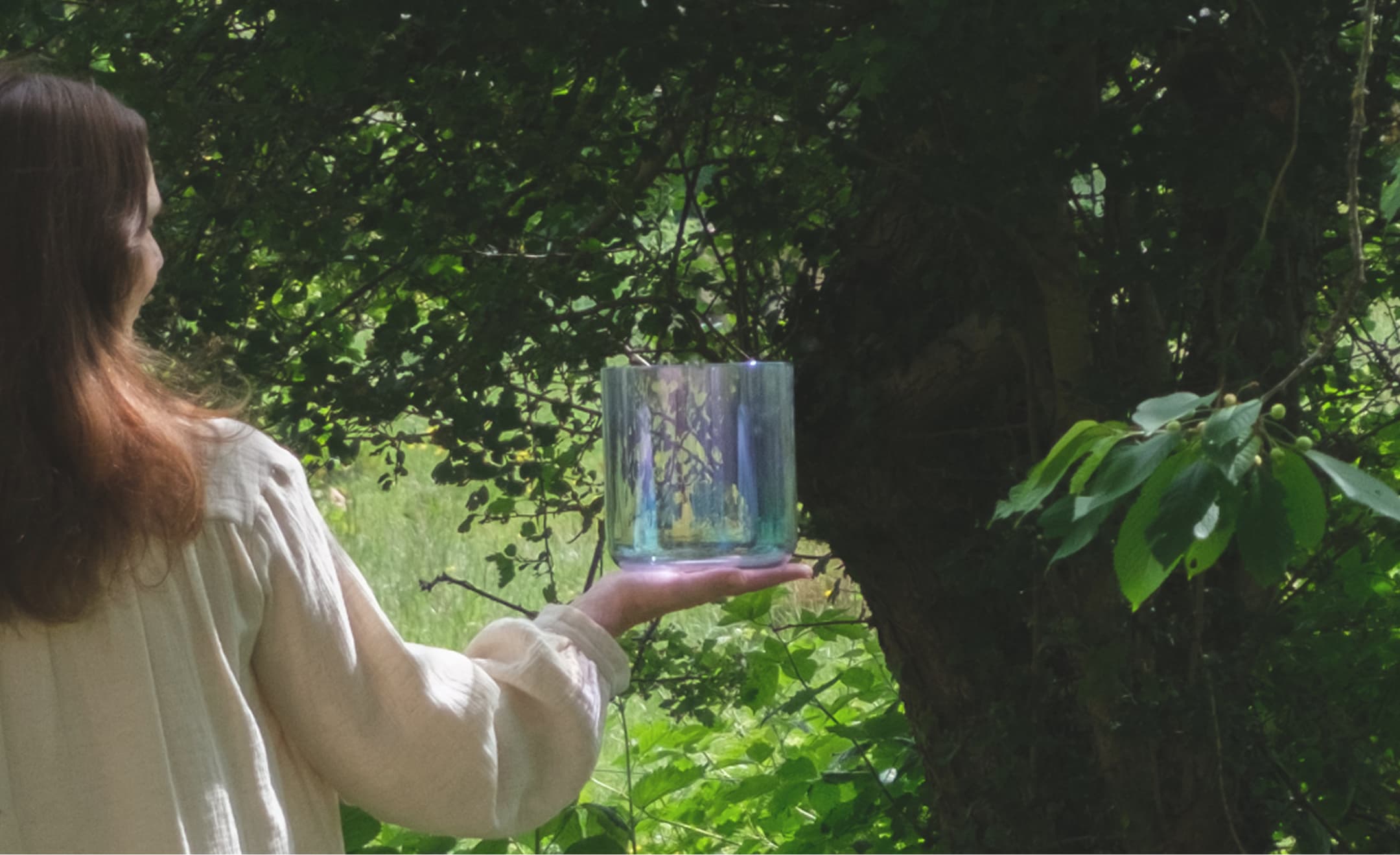 Gabi holding a crystal bowl in nature